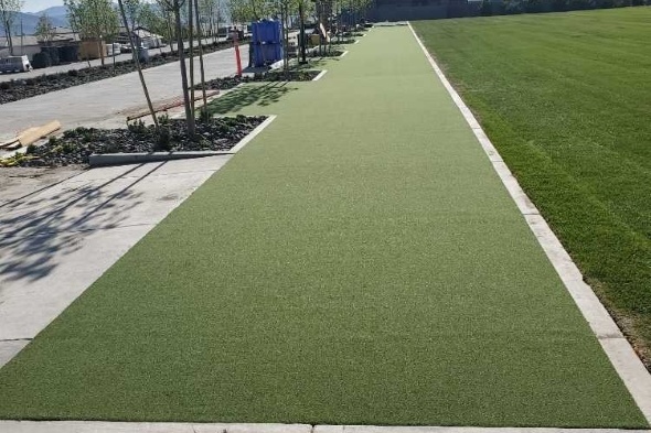 Los Angeles and Southern California Outdoor tee line consisting of one continuous green synthetic grass strip surrounded by trees